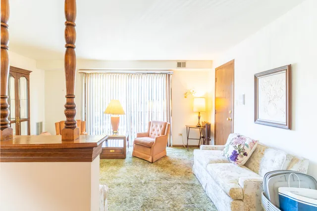 a living room with furniture and large windows