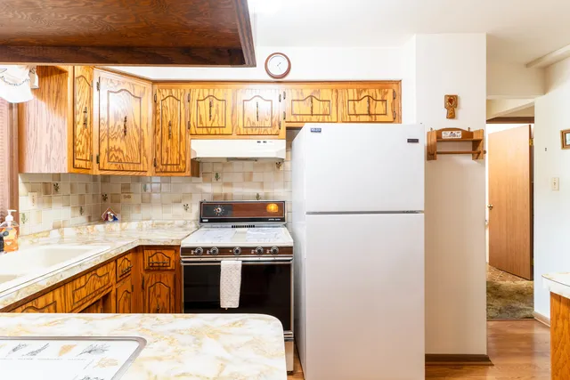 a kitchen with a refrigerator and a sink