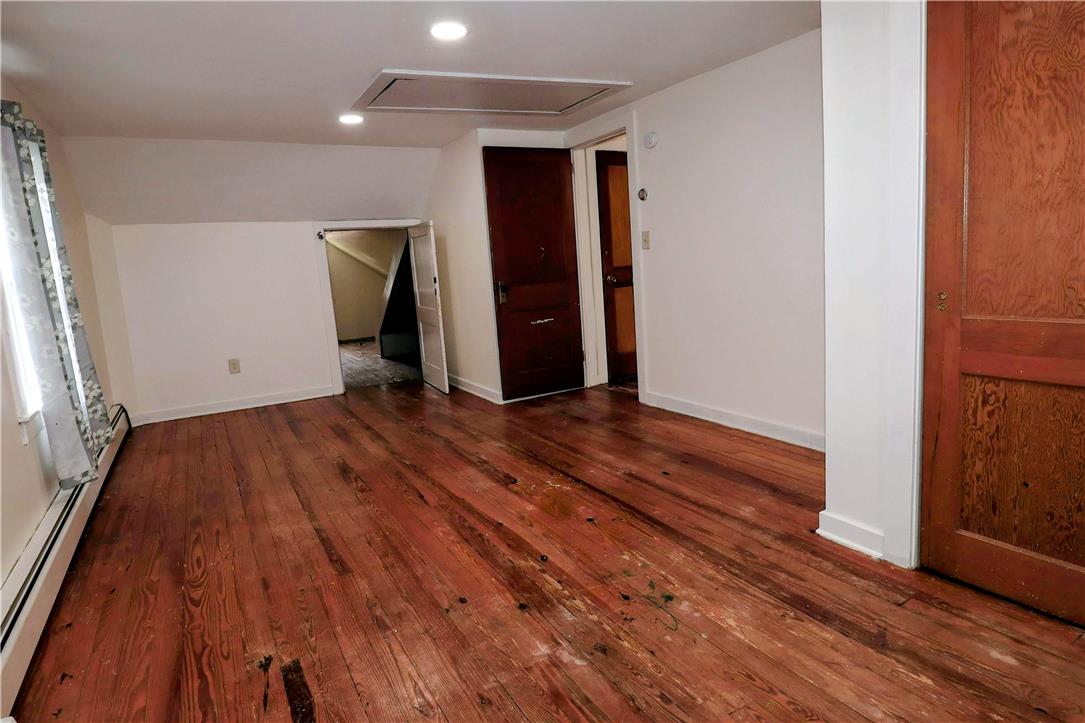 172 Harrison Street Emmaus, PA 18049 - Photo 17 of 30 Rich hardwood flooring stretches across this naturally illuminated room, featuring convenient attic access.