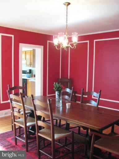 3629 Elkader Road Baltimore, MD 21218 - Photo 4 of 19 a view of a dining room with furniture window and chandelier