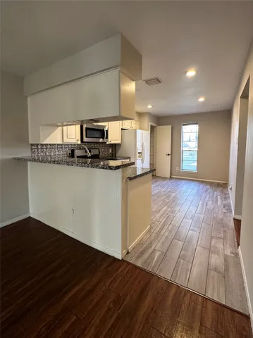 a kitchen with granite countertop a stove and a sink