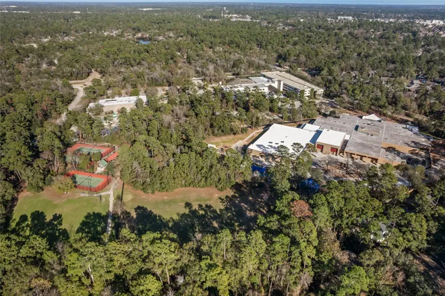 an aerial view of residential house with parking and yard