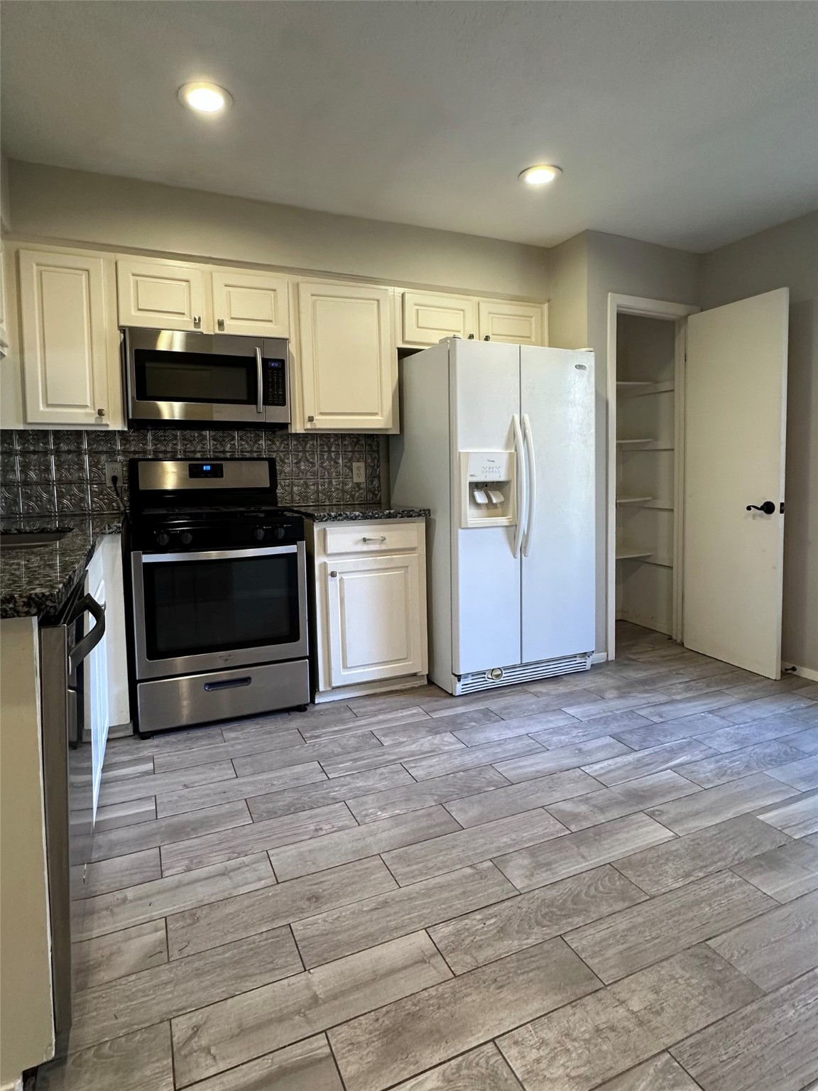 3223 Brooktree Lane Spring, TX 77380 - Photo 4 of 30 a kitchen with stainless steel appliances and a refrigerator
