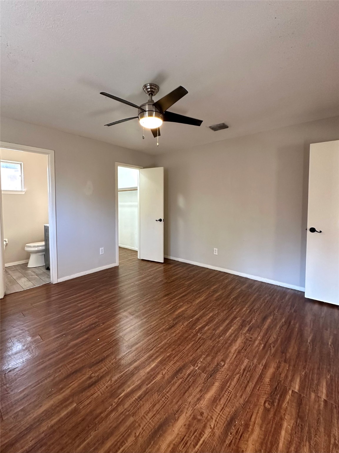 3223 Brooktree Lane Spring, TX 77380 - Photo 8 of 30 a view of an empty room with wooden floor and a ceiling fan