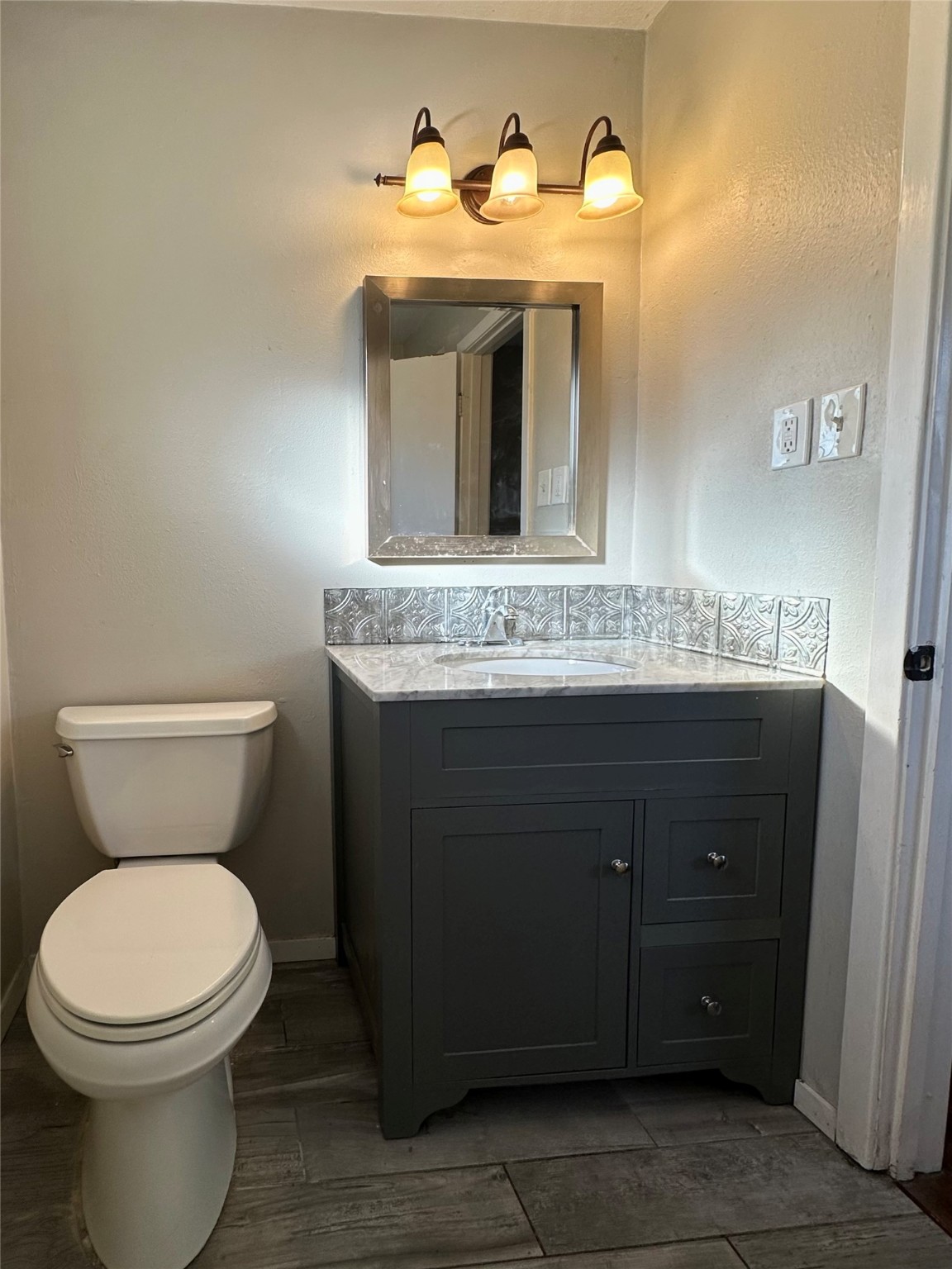 3223 Brooktree Lane Spring, TX 77380 - Photo 10 of 30 a bathroom with a toilet sink and mirror