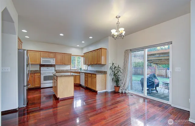 a view of kitchen with breakfast area and windows