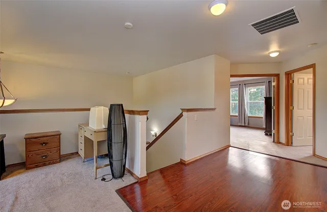 a view of a livingroom with furniture and stairs