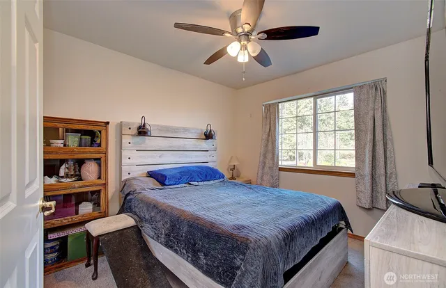 a bedroom with a large bed and a chandelier