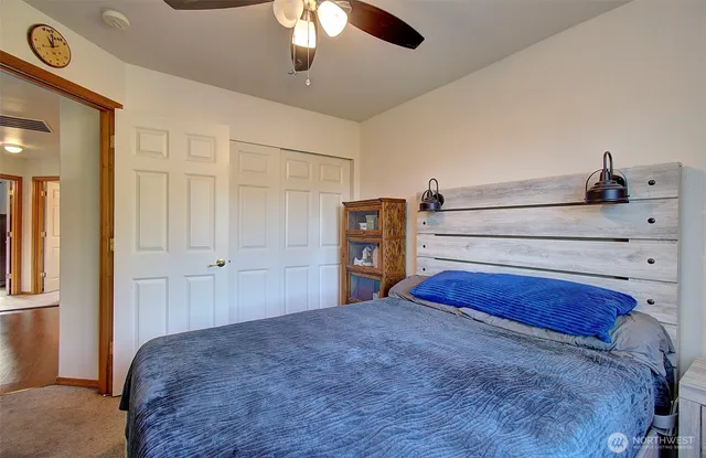 a bedroom with a bed and cabinets