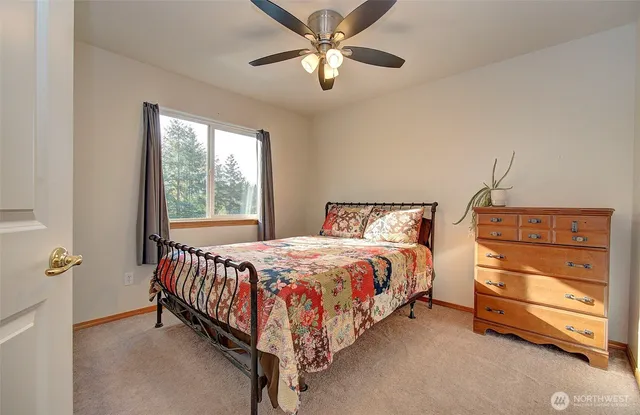 a bed sitting in a bedroom next to a window