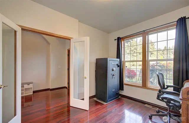 a view of a room with wooden floor and windows