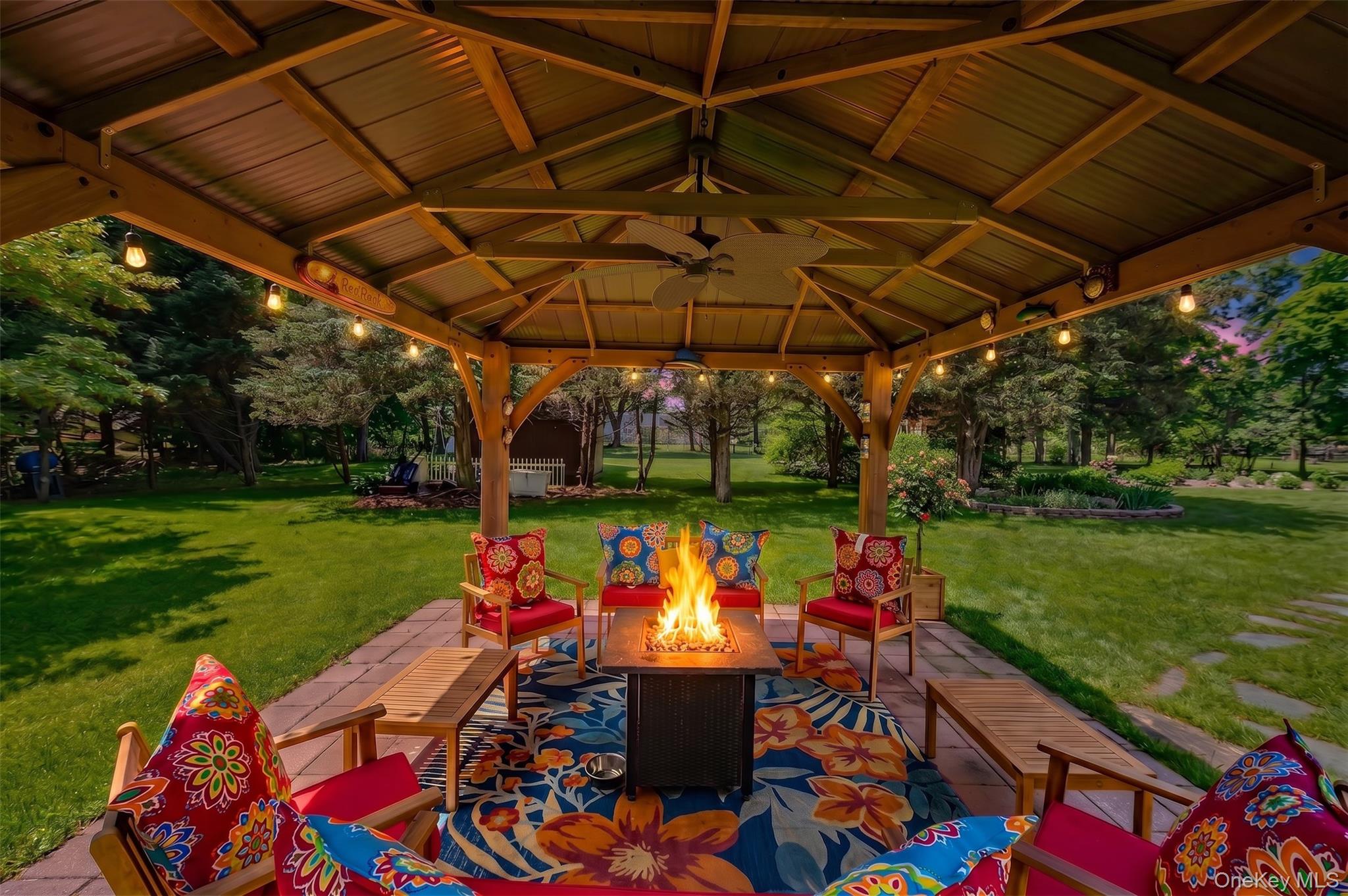3 Thompson Hill Road St. James, NY 11780 - Photo 29 of 34 a view of a patio with a table and chairs under an umbrella