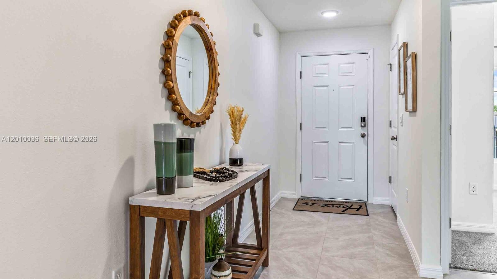 9871 Southeast 161st Lane Road Summerfield, FL 34491 - Photo 5 of 31 a view of a livingroom with wooden floor and entryway
