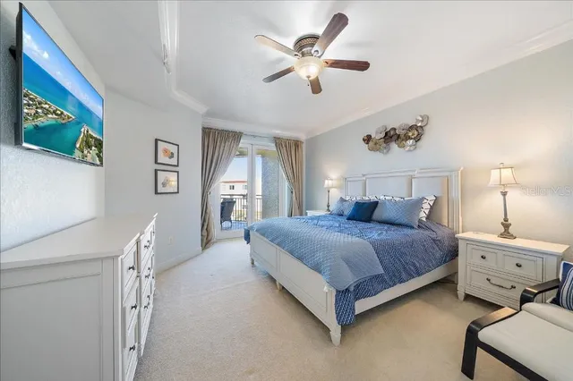 a bedroom with a bed chandelier and a window