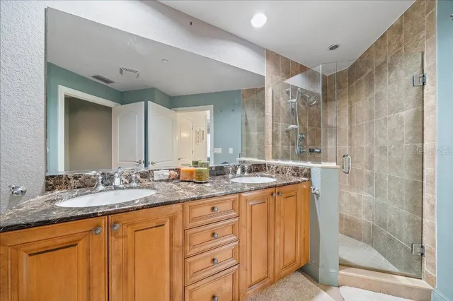 a bathroom with a granite countertop sink mirror and double