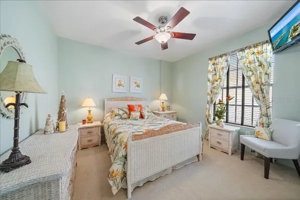 a bedroom with a bed couch and a window