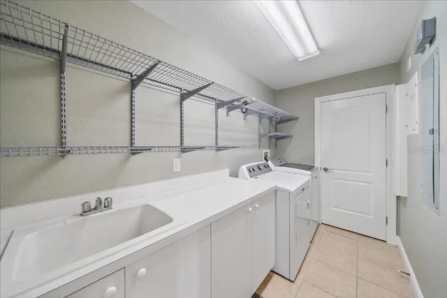 a utility room with a sink dryer and washer