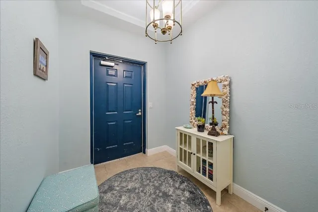 a bedroom with a bed and a chandelier