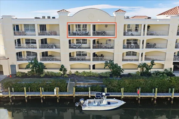 a view of house with lake view and a garden