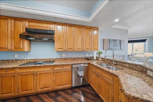 a kitchen with stainless steel appliances granite countertop a sink stove and cabinets