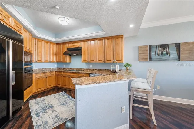 a kitchen with cabinets and wooden floor