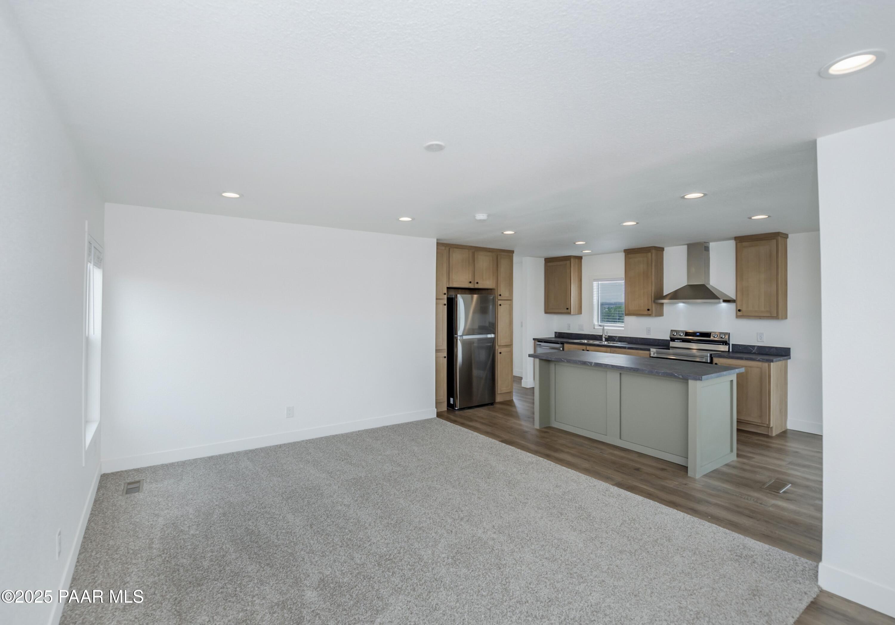 25671 St John Road Paulden, AZ 86334 - Photo 5 of 24 a large kitchen with stainless steel appliances a refrigerator and a sink