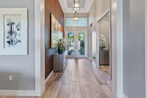 a dining hall with stainless steel appliances granite countertop a table chairs and a refrigerator