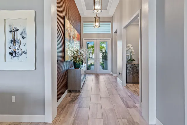 a dining hall with stainless steel appliances granite countertop a table chairs and a refrigerator