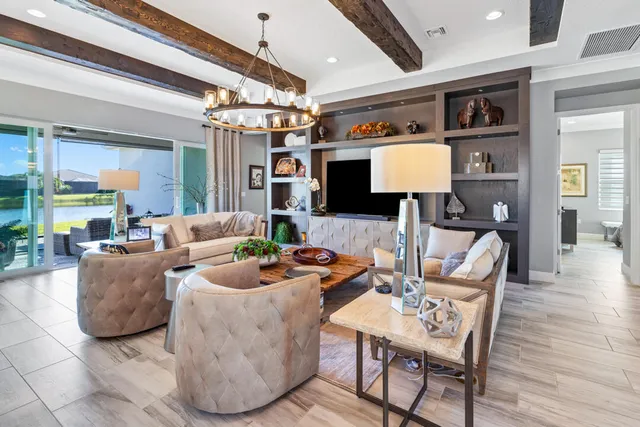 a bedroom with a large bed and a chandelier