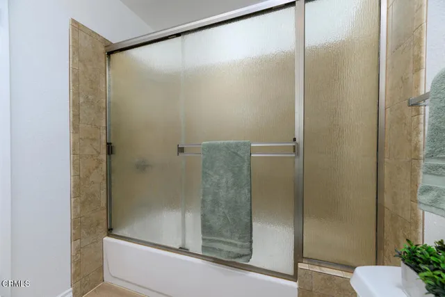 a bathroom with a glass shower door