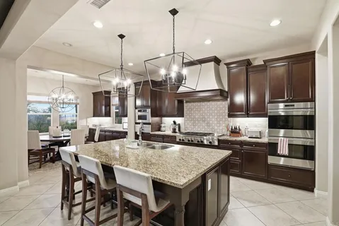 a kitchen with granite countertop a stove and a sink