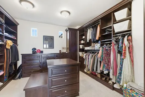 a living room with couches and chandelier