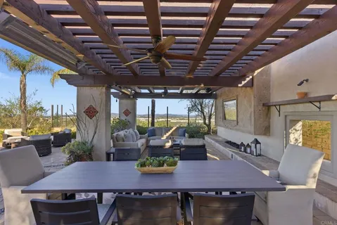a view of a patio with a table and chairs