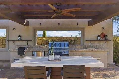 a bedroom with furniture and a large window