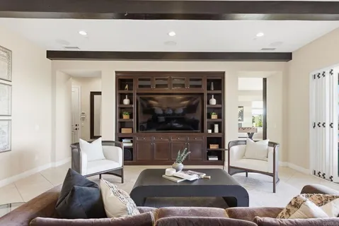 a dining room with furniture and a large window