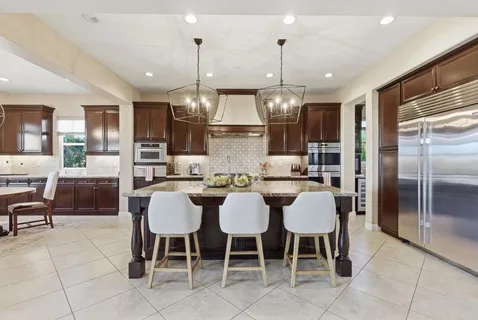 a view of a dining room with furniture a chandelier and wooden floor