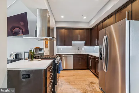 a kitchen with a refrigerator sink and stove