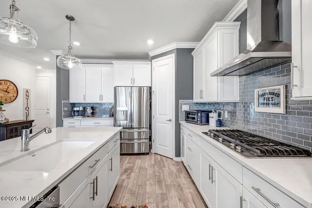 a view of a dining room with furniture a chandelier and wooden floor