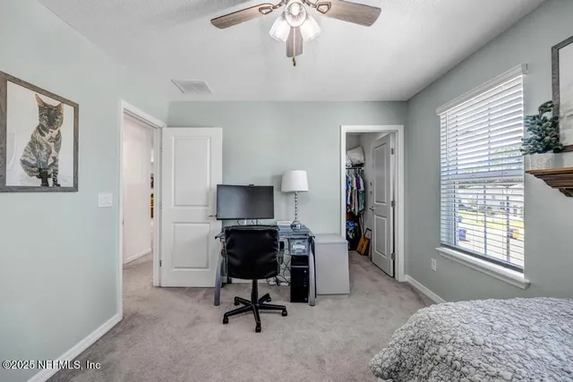 a swimming pool with lawn chairs and a yard