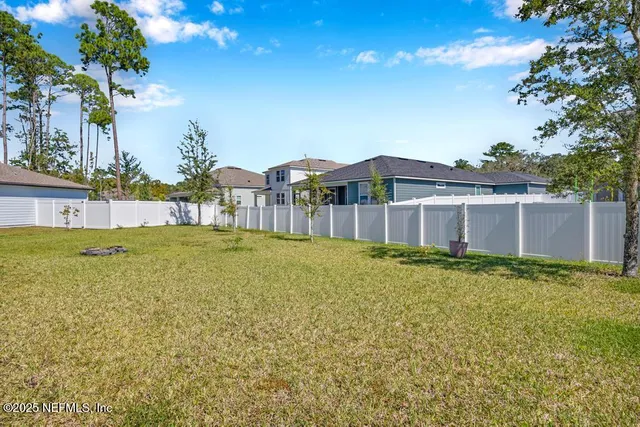 a view of a house with swimming pool and a yard