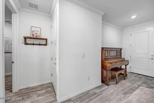 a view of workspace with furniture and paintings on wall