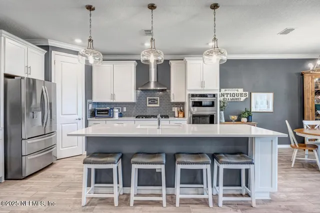 a kitchen with kitchen island granite countertop a sink stove and refrigerator