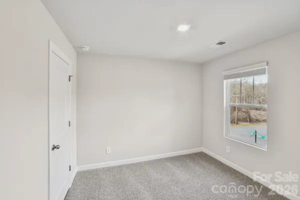 a view of an empty room with racks on the wall