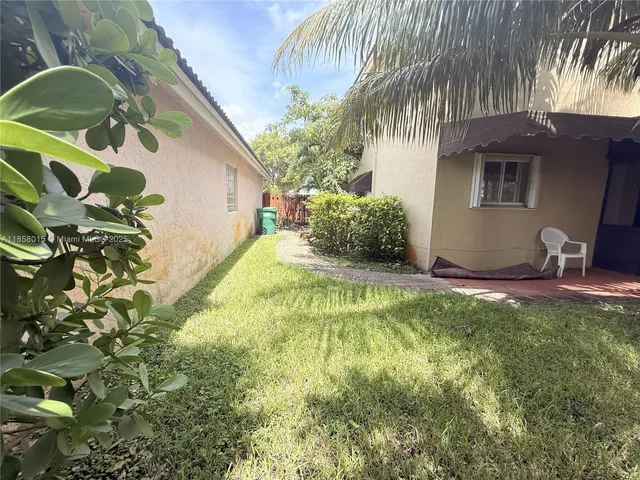 a view of a backyard with a tree
