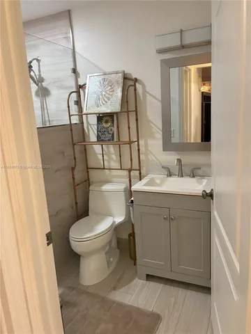a bathroom with a sink toilet and mirror