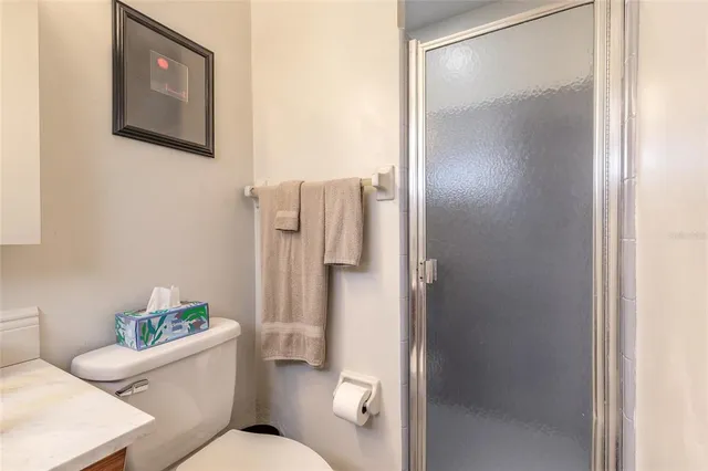 a bathroom with a toilet sink and shower