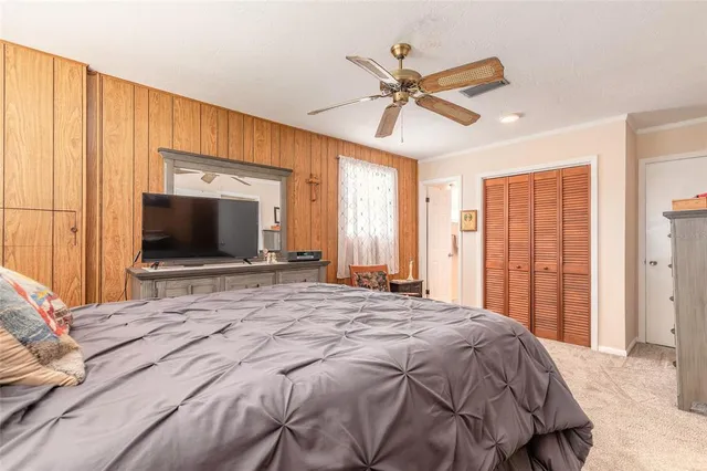 a bedroom with a large bed and a flat screen tv