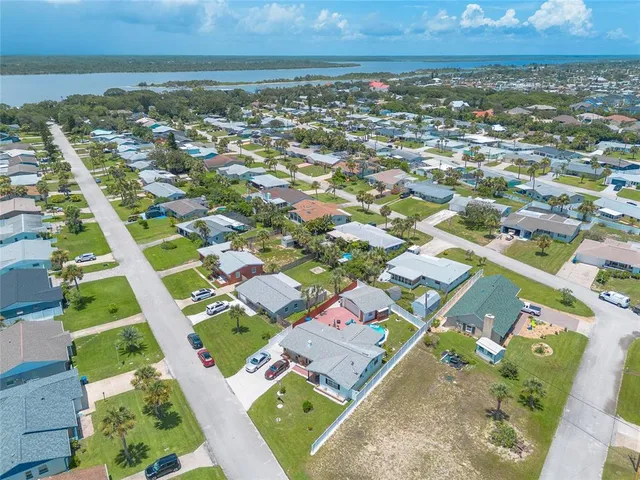 an aerial view of residential houses with outdoor space