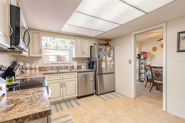 a kitchen with refrigerator and window