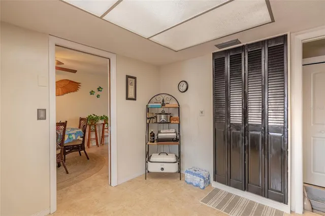 a view of a hallway with closet and outdoor seating
